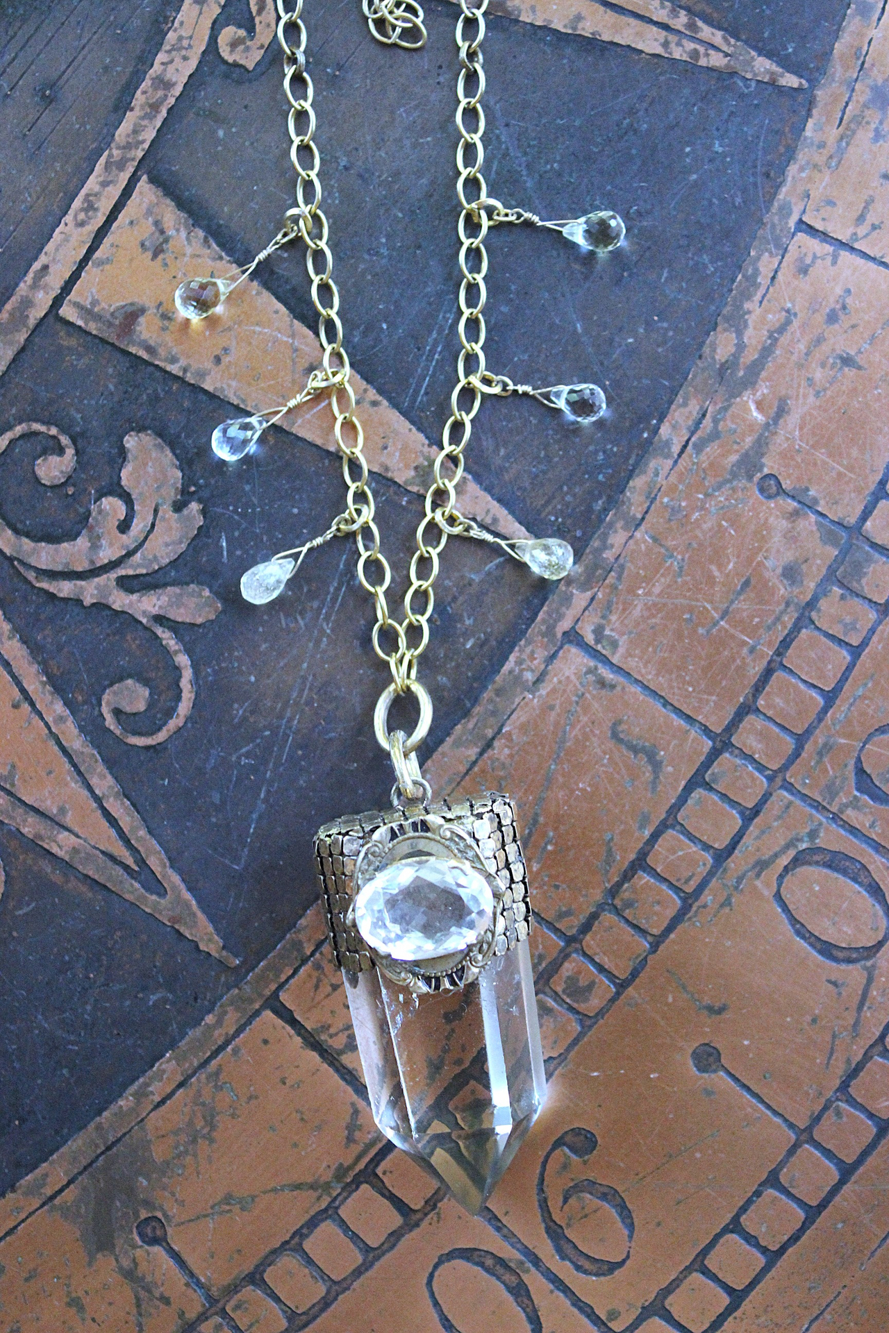 It is a Dawn Necklace w/Antique Gold Mesh Capped Light Citrine Quartz Point,Antique Faceted Rock Crystal Stone & Finding, Faceted Citrine & Clear Rock Quartz Briolletes