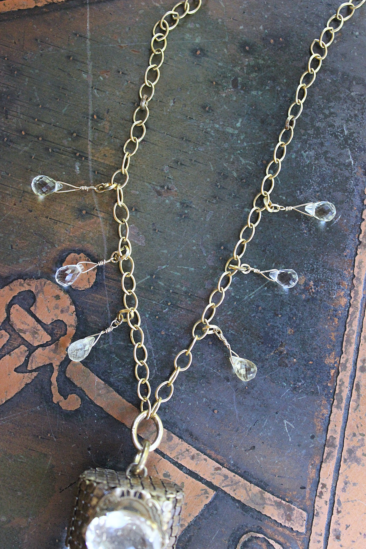 It is a Dawn Necklace w/Antique Gold Mesh Capped Light Citrine Quartz Point,Antique Faceted Rock Crystal Stone & Finding, Faceted Citrine & Clear Rock Quartz Briolletes