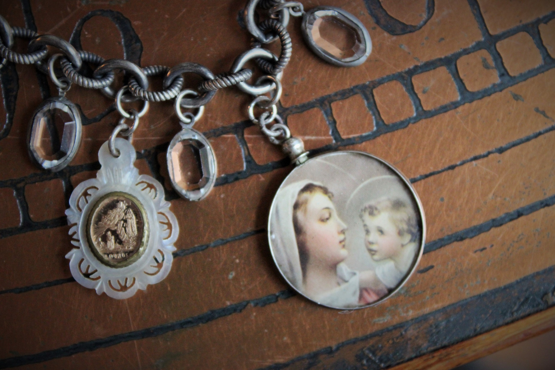 All over the Sky Bracelet w/Antique French Medals, Sterling Chain,Antique Glass Picture Locket, 2 Rare Tiny Glass Bubble Lockets,Antique Sterling "Rattle", Antique MOP Glass Inset Notre Dame Drop & More!