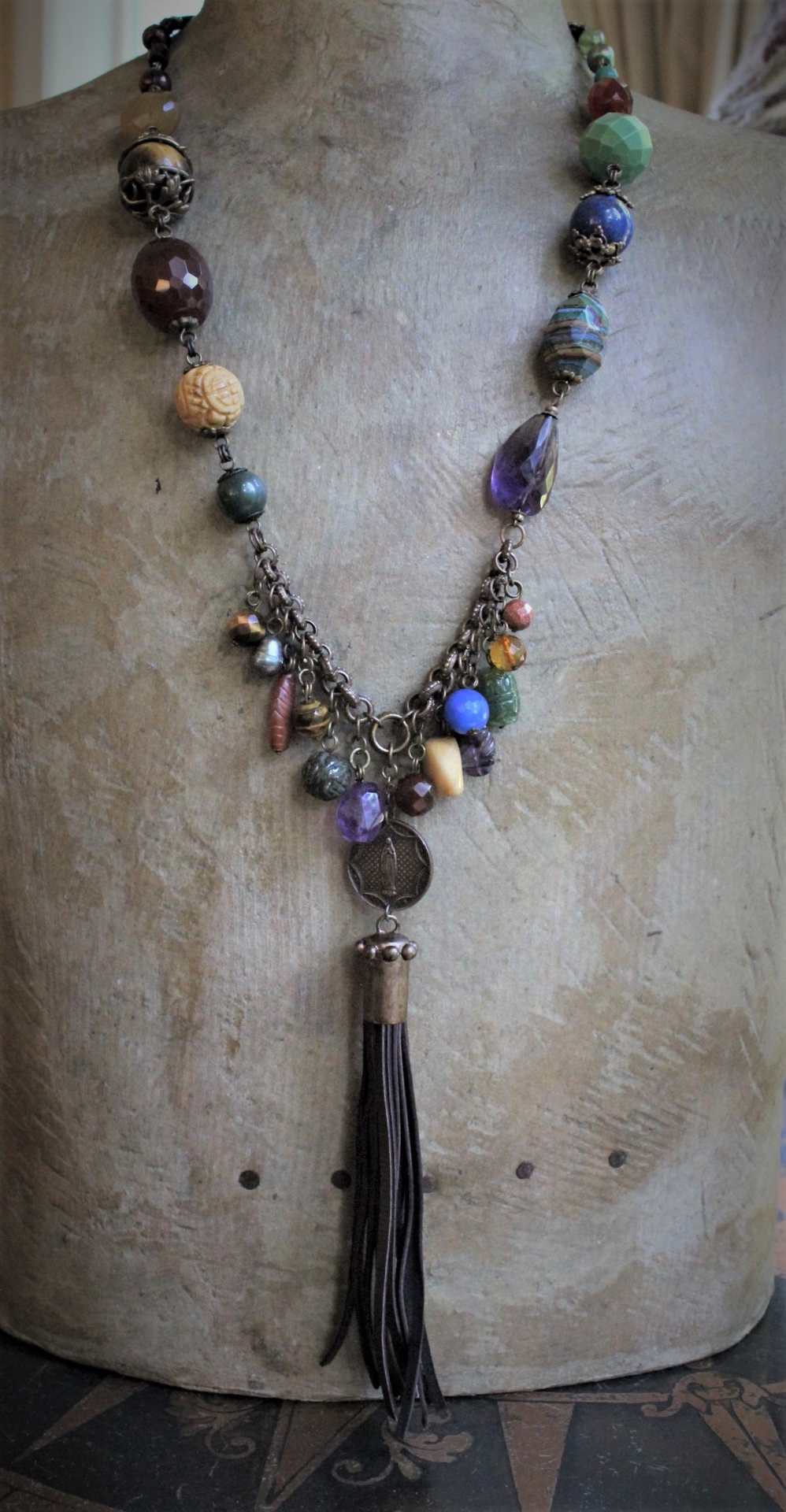 In the Whispers Necklace with Multi Faceted & Polished Gemstones, Antique French Our Lady of Lourdes Medal, Leather Tassel, Leather Ties