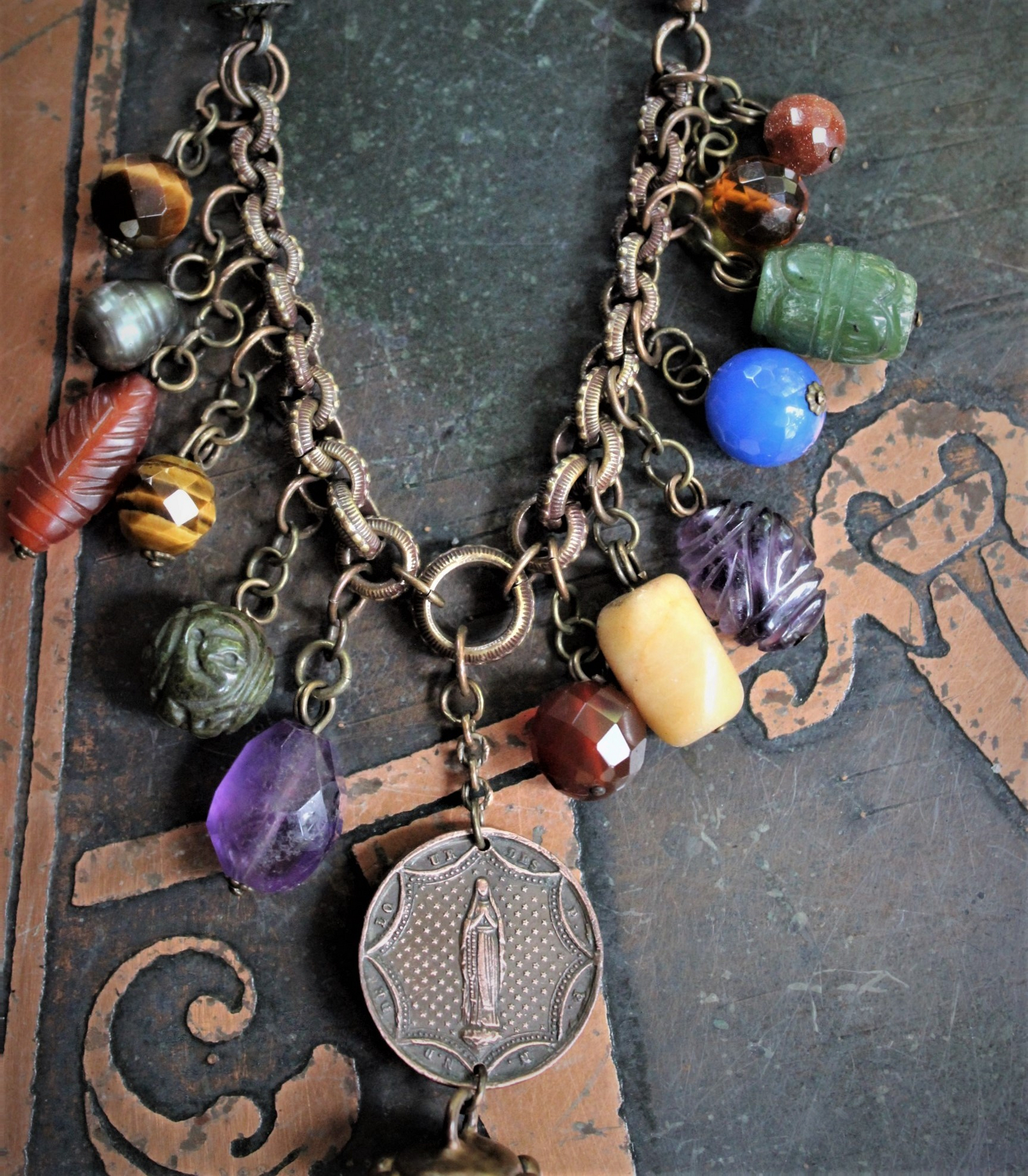 In the Whispers Necklace with Multi Faceted & Polished Gemstones, Antique French Our Lady of Lourdes Medal, Leather Tassel, Leather Ties